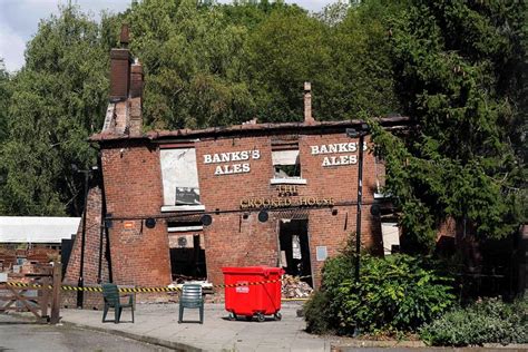 Police arrest two men in suspected torching of British pub cherished for its lopsided walls